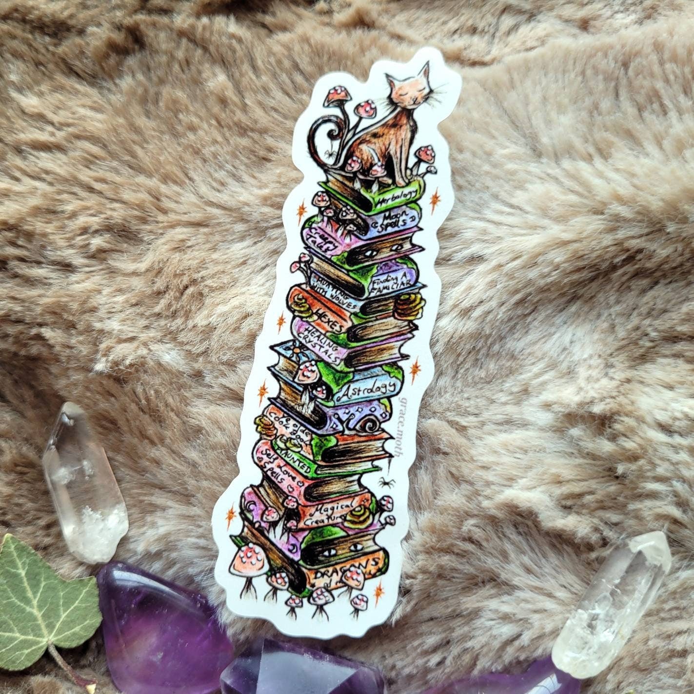 Witchy kitty book pile - Vinyl Sticker 10cm by 3cm Illustrated by Grace moth. Witches familiar, spell books, magic, fantasy, mushrooms