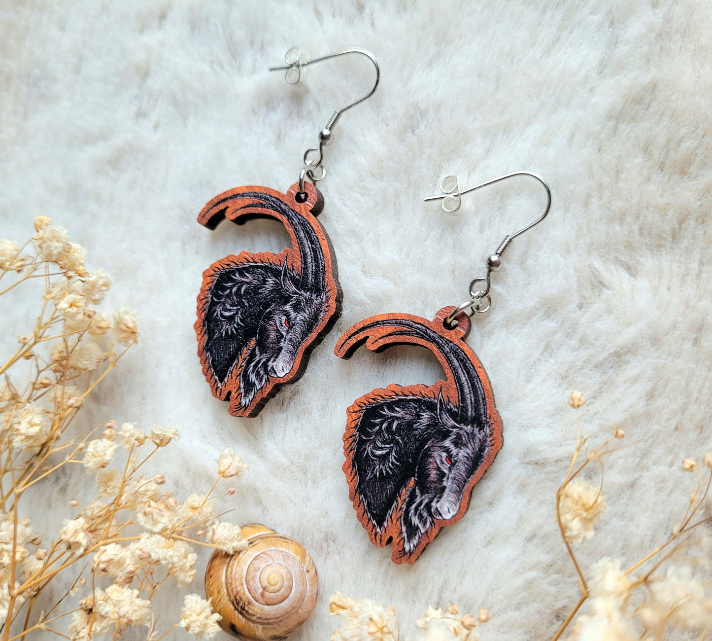 Black Phillip Goat illustrated earrings, responsibly sourced cherry wood, 304 Stainless Steel hooks, by Grace Moth
